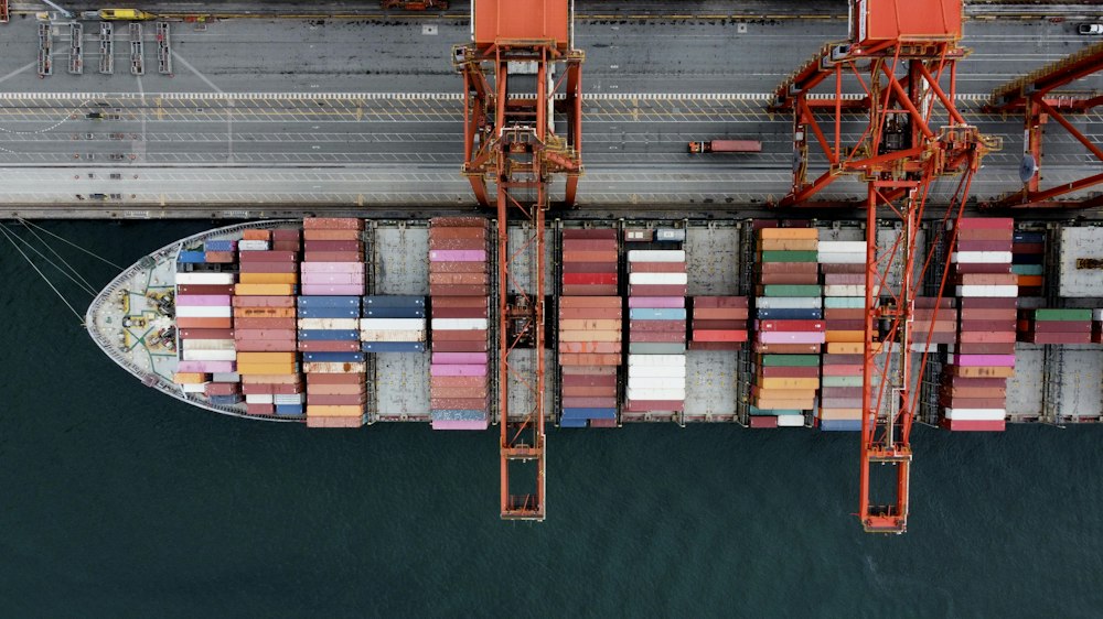 Aerial view of a container ship alongside port cranes